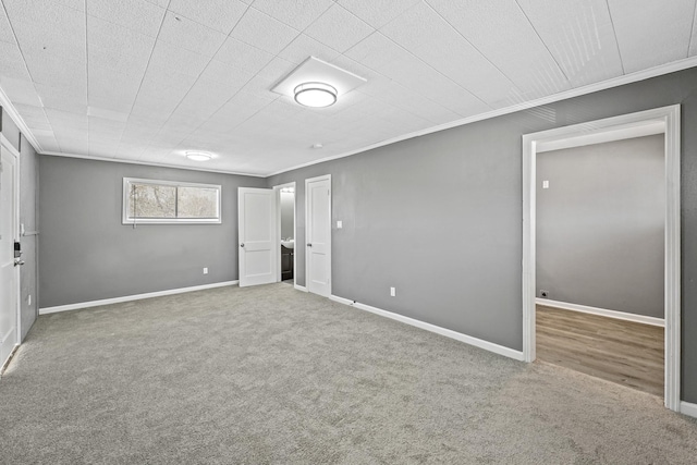 unfurnished bedroom featuring crown molding and carpet