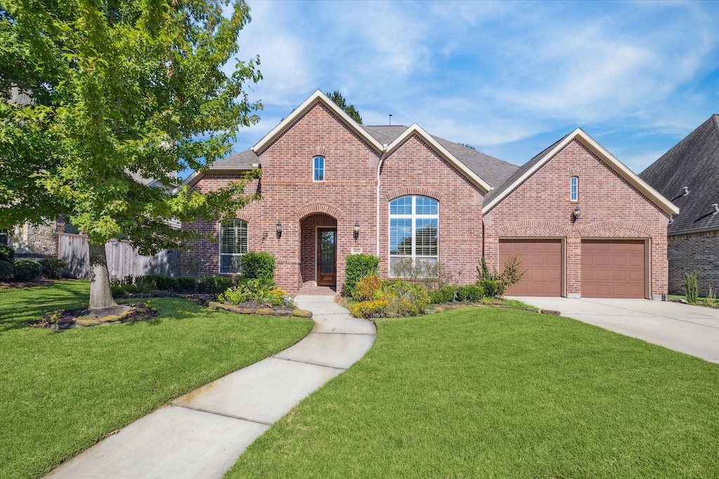 view of front of home featuring a garage and a front lawn