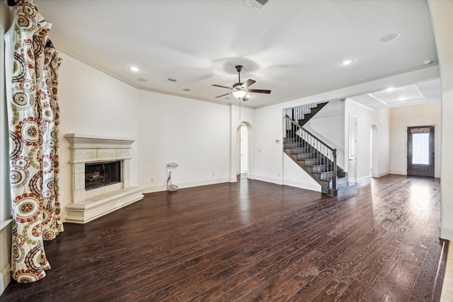 unfurnished living room featuring hardwood / wood-style flooring, a fireplace, ornamental molding, and ceiling fan