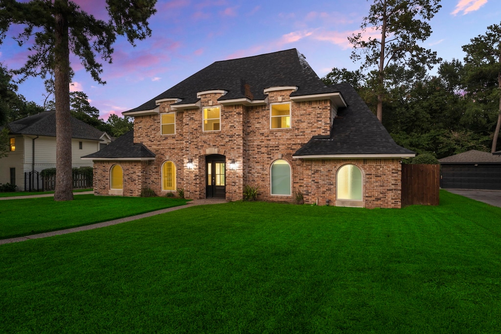 french country style house with a lawn