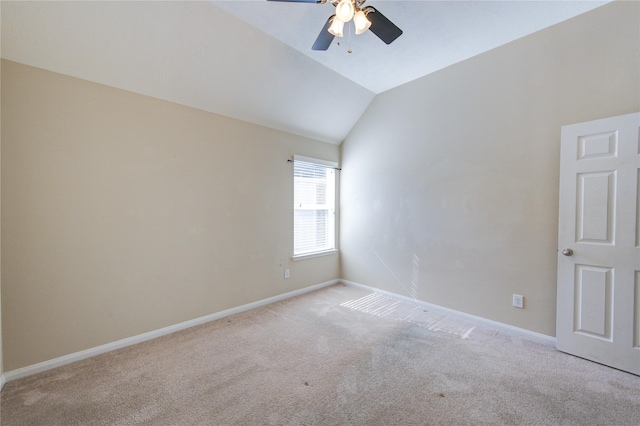 carpeted empty room featuring vaulted ceiling and ceiling fan