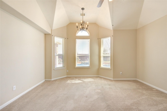 unfurnished room featuring ceiling fan with notable chandelier, vaulted ceiling, light colored carpet, and a healthy amount of sunlight