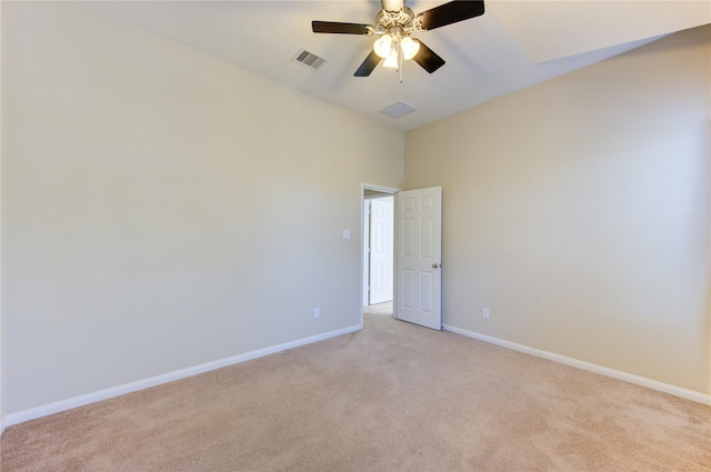 carpeted spare room with ceiling fan