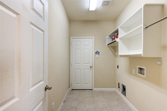 washroom featuring gas dryer hookup, electric dryer hookup, washer hookup, and light tile patterned floors