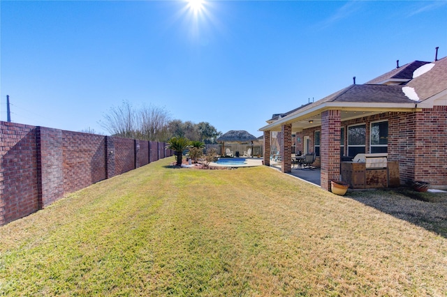 view of yard with a fenced in pool and a patio