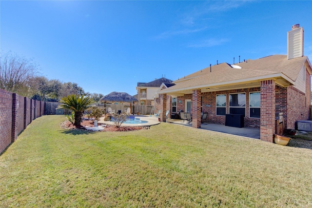 view of yard with a fenced in pool and a patio