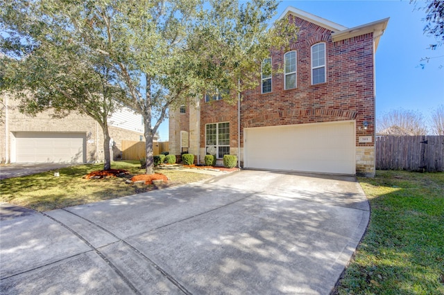 traditional-style house featuring an attached garage, brick siding, fence, concrete driveway, and a front lawn