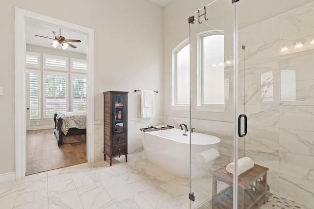 bathroom featuring ceiling fan, plus walk in shower, and tile walls