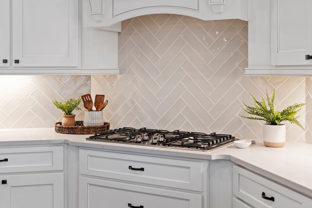 kitchen with white cabinetry, stainless steel gas cooktop, and tasteful backsplash