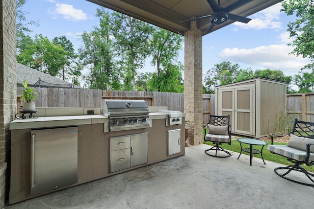 view of patio with ceiling fan, area for grilling, and grilling area