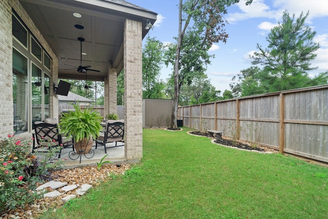 view of yard featuring a patio and ceiling fan