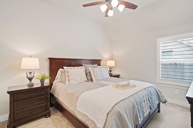 carpeted bedroom with ceiling fan and vaulted ceiling