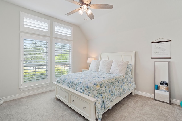 bedroom with lofted ceiling, light colored carpet, and ceiling fan