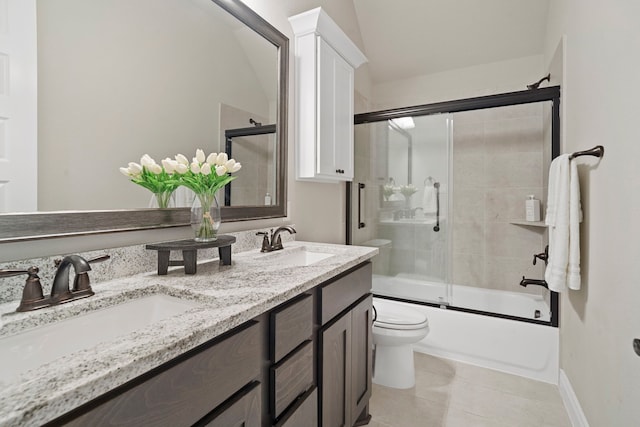 full bathroom featuring toilet, vanity, shower / bath combination with glass door, and tile patterned flooring