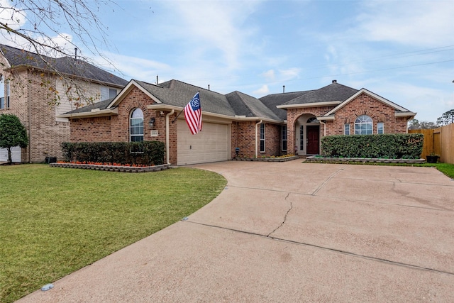 ranch-style home with a garage and a front yard