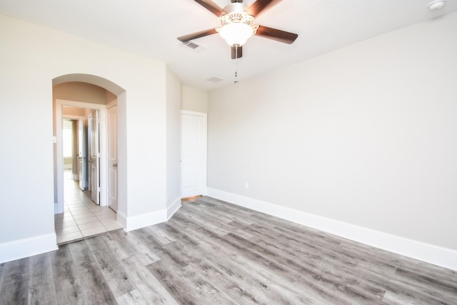 spare room with ceiling fan and light hardwood / wood-style flooring