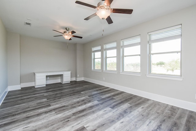 unfurnished living room with ceiling fan and dark hardwood / wood-style flooring