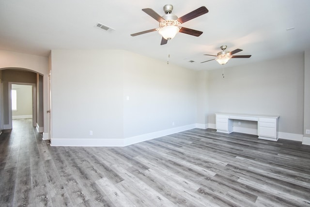 unfurnished living room featuring hardwood / wood-style floors and ceiling fan