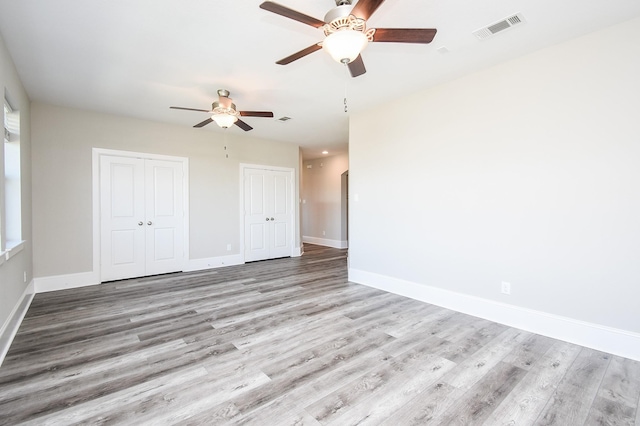 unfurnished room with ceiling fan and light wood-type flooring