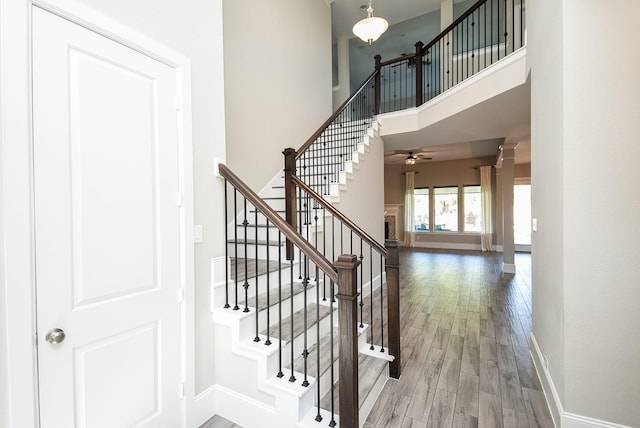 stairway featuring hardwood / wood-style floors and a high ceiling