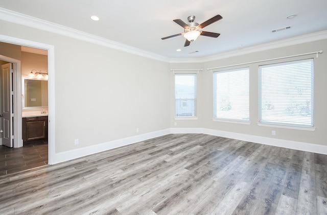 spare room featuring ornamental molding, ceiling fan, and light wood-type flooring