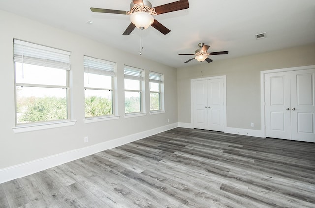 unfurnished bedroom with hardwood / wood-style floors and ceiling fan