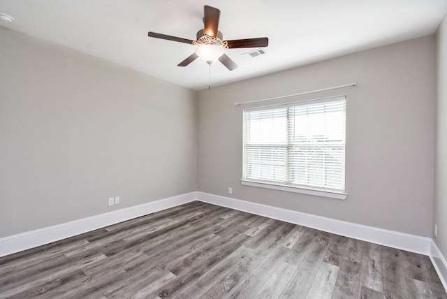 empty room featuring hardwood / wood-style flooring and ceiling fan