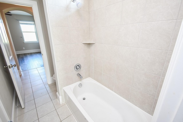 bathroom with a bath and tile patterned flooring