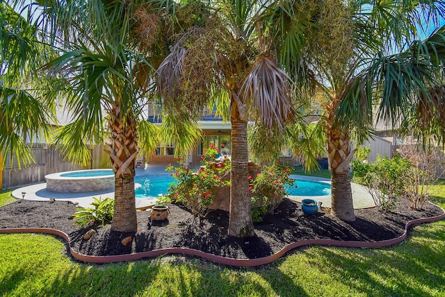 view of swimming pool with an in ground hot tub