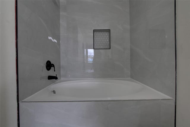 bathroom featuring tiled bath