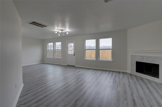 unfurnished living room with a fireplace and light hardwood / wood-style flooring