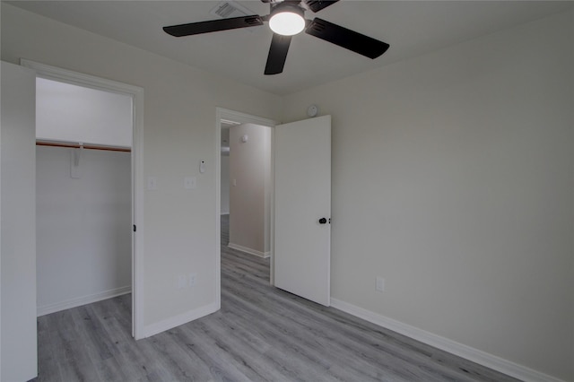 unfurnished bedroom with ceiling fan, light hardwood / wood-style floors, and a closet