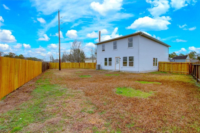 rear view of house with a yard