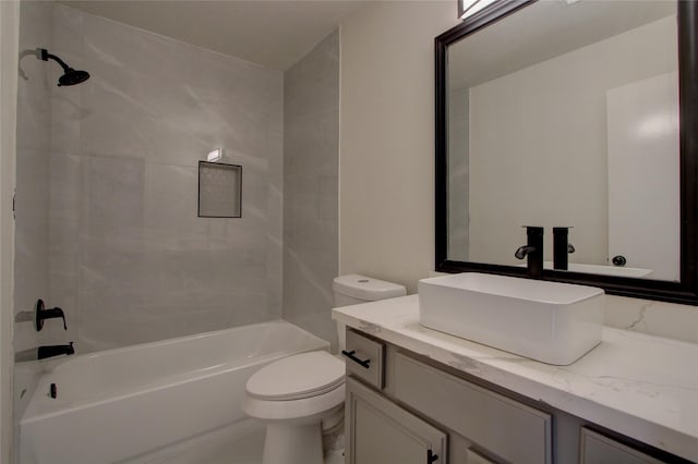 full bathroom with vanity, toilet, and tiled shower / bath combo