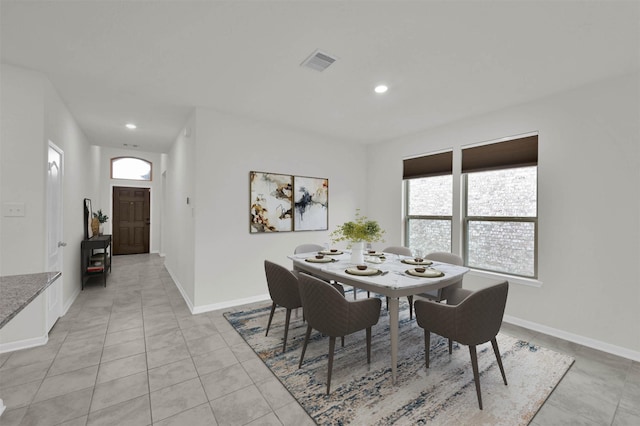 tiled dining space with a healthy amount of sunlight