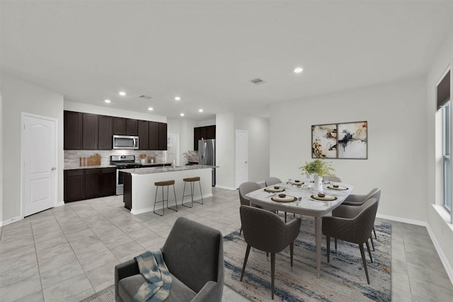 dining room with sink and light tile patterned floors