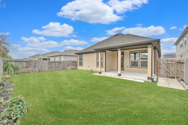 back of house featuring a yard and a patio area