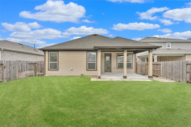 back of house with a patio and a lawn