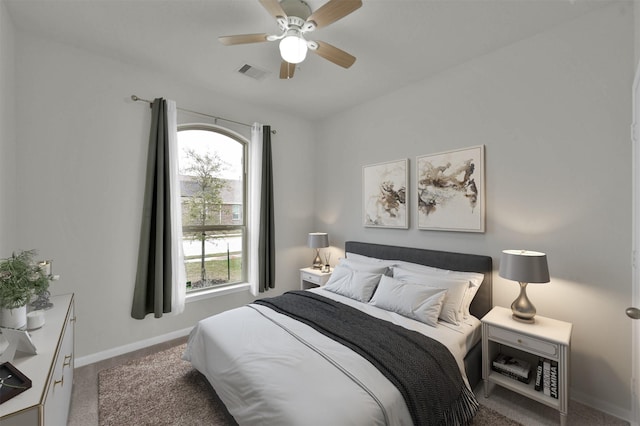 carpeted bedroom featuring ceiling fan and multiple windows