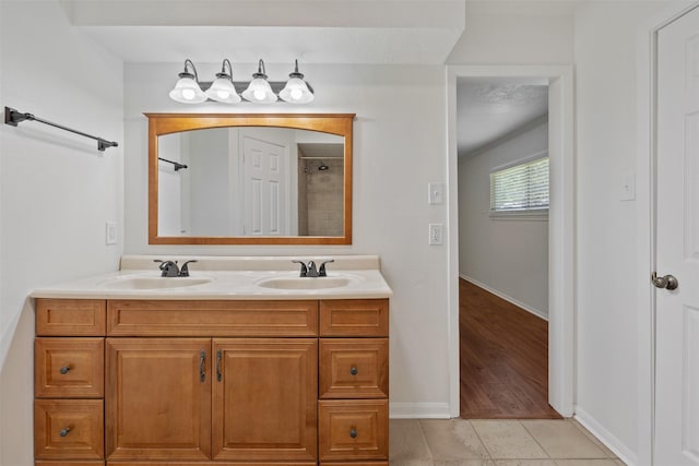 bathroom with walk in shower, tile patterned floors, and vanity