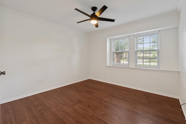 spare room featuring dark wood-type flooring, ceiling fan, and ornamental molding