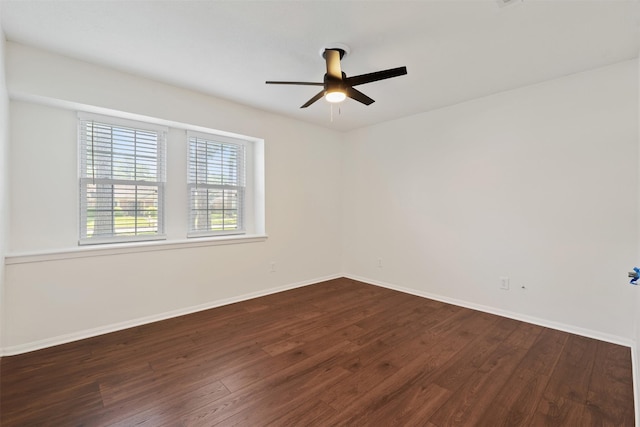 empty room featuring dark wood-type flooring and ceiling fan