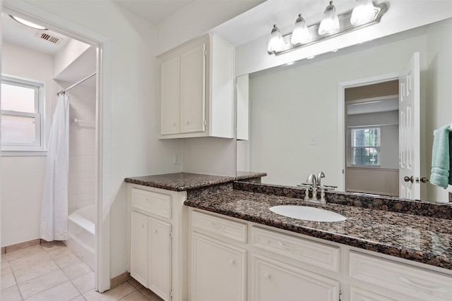 bathroom with vanity, shower / bath combination with curtain, and tile patterned floors