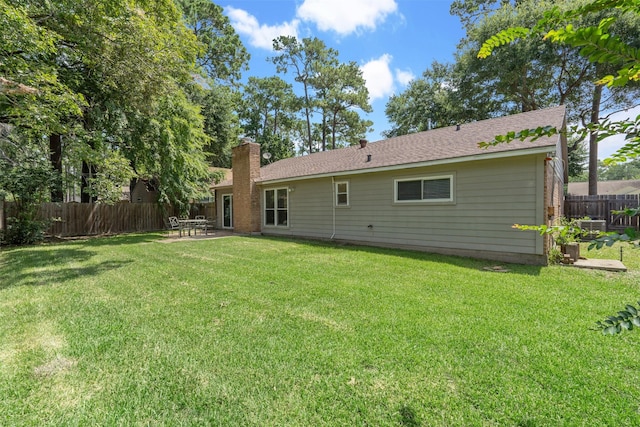 back of house featuring a lawn