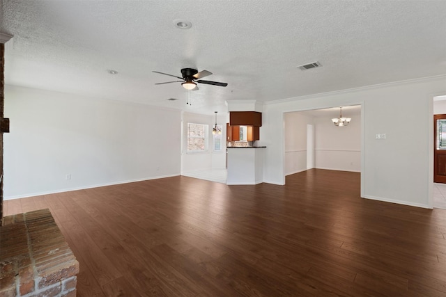 unfurnished living room with dark hardwood / wood-style flooring, ceiling fan with notable chandelier, and a textured ceiling