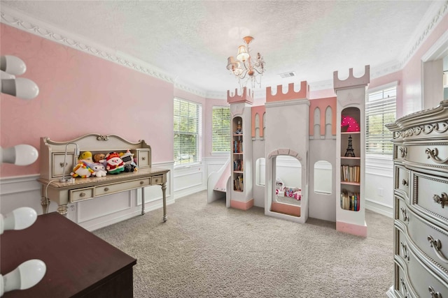 bedroom with a textured ceiling, a wainscoted wall, carpet flooring, visible vents, and an inviting chandelier