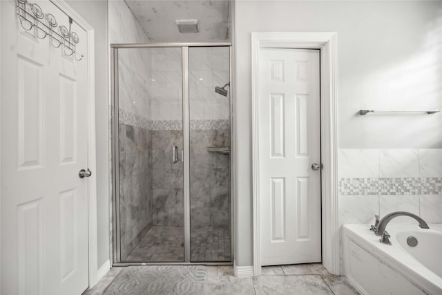 full bath featuring a garden tub and a shower stall