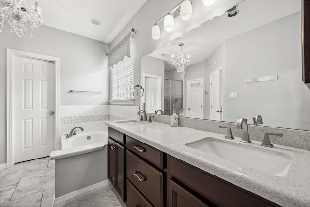 full bathroom featuring a bath, a stall shower, a chandelier, and a sink