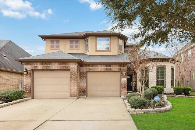 view of front of property featuring brick siding, concrete driveway, roof with shingles, stucco siding, and a front yard