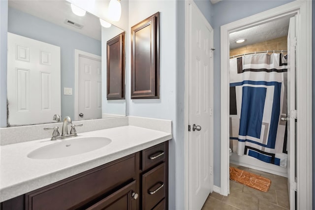 full bathroom with tile patterned flooring, visible vents, vanity, and curtained shower